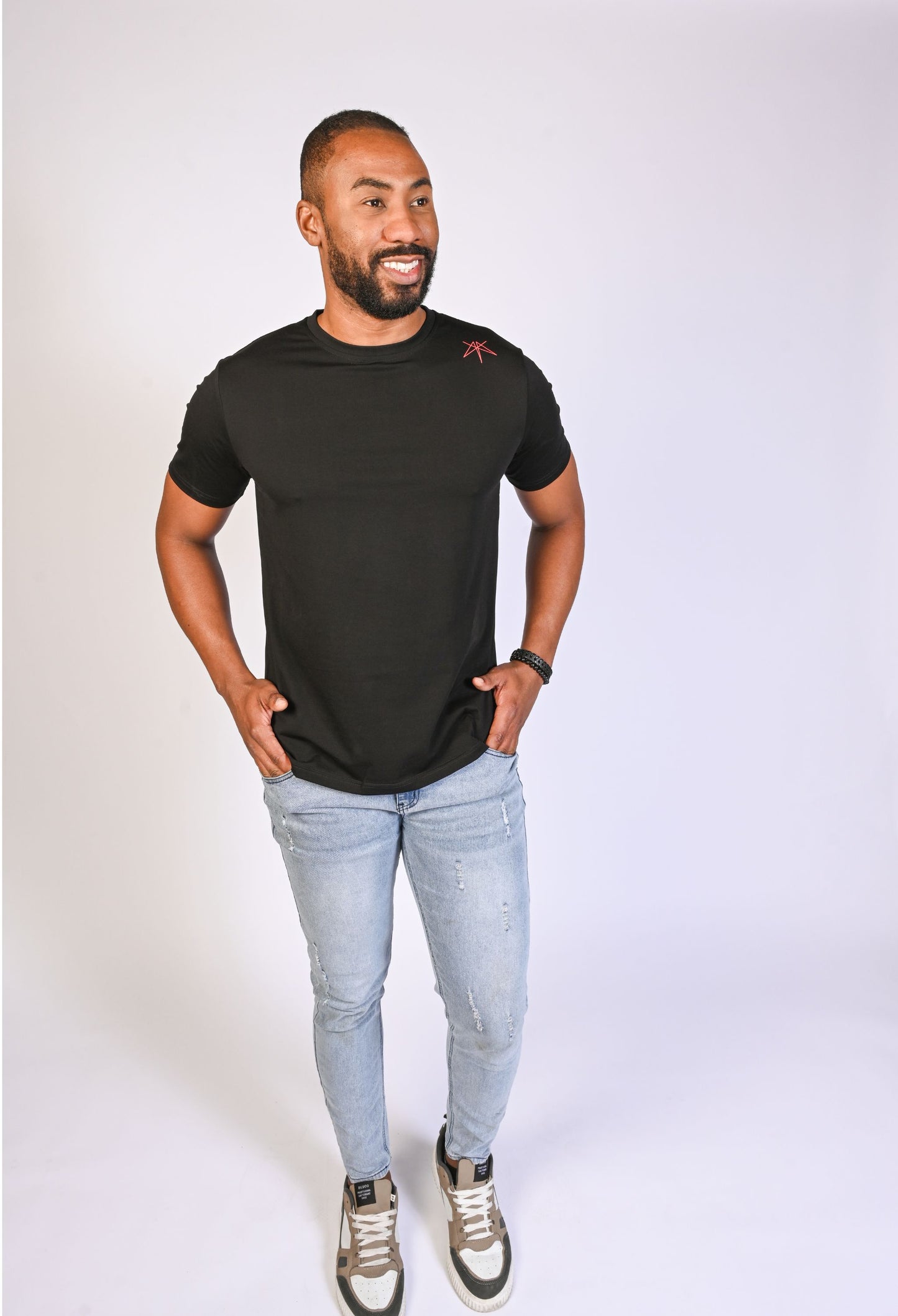 Model in a black Clay & Ash organic cotton WeaveForm T-shirt, front view with a modern fit and minimalist design. Elevate your wardrobe with sustainable, high-quality men’s fashion