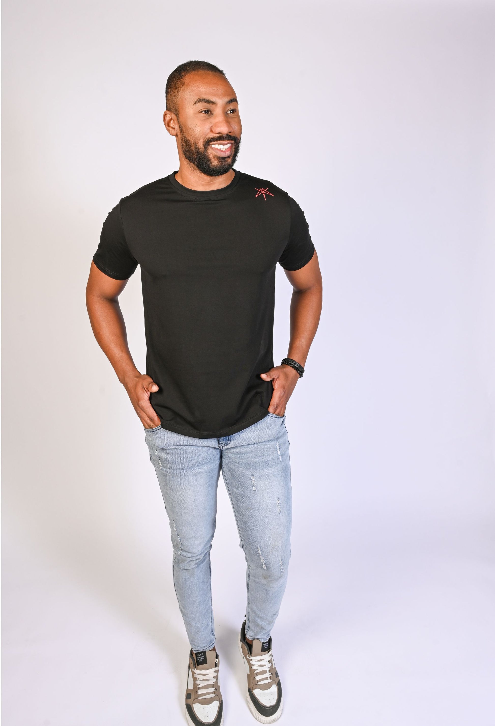 Model in a black Clay & Ash organic cotton WeaveForm T-shirt, front view with a modern fit and minimalist design. Elevate your wardrobe with sustainable, high-quality men’s fashion