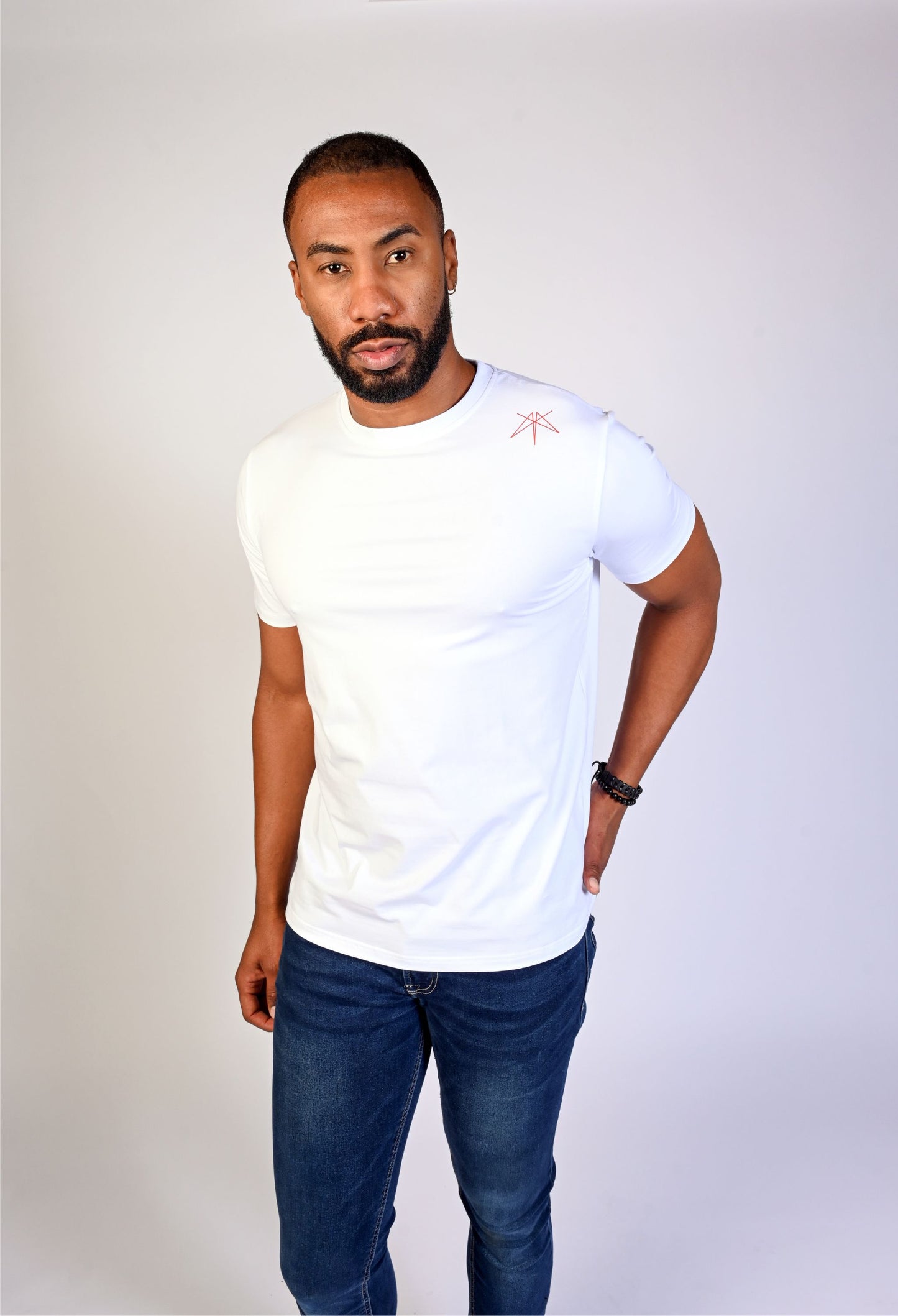 Model wearing a white Clay & Ash organic cotton WeaveForm T-shirt, front view showcasing the sustainable fashion design with logo detail on the shoulder. Shop now for eco-conscious and comfortable apparel