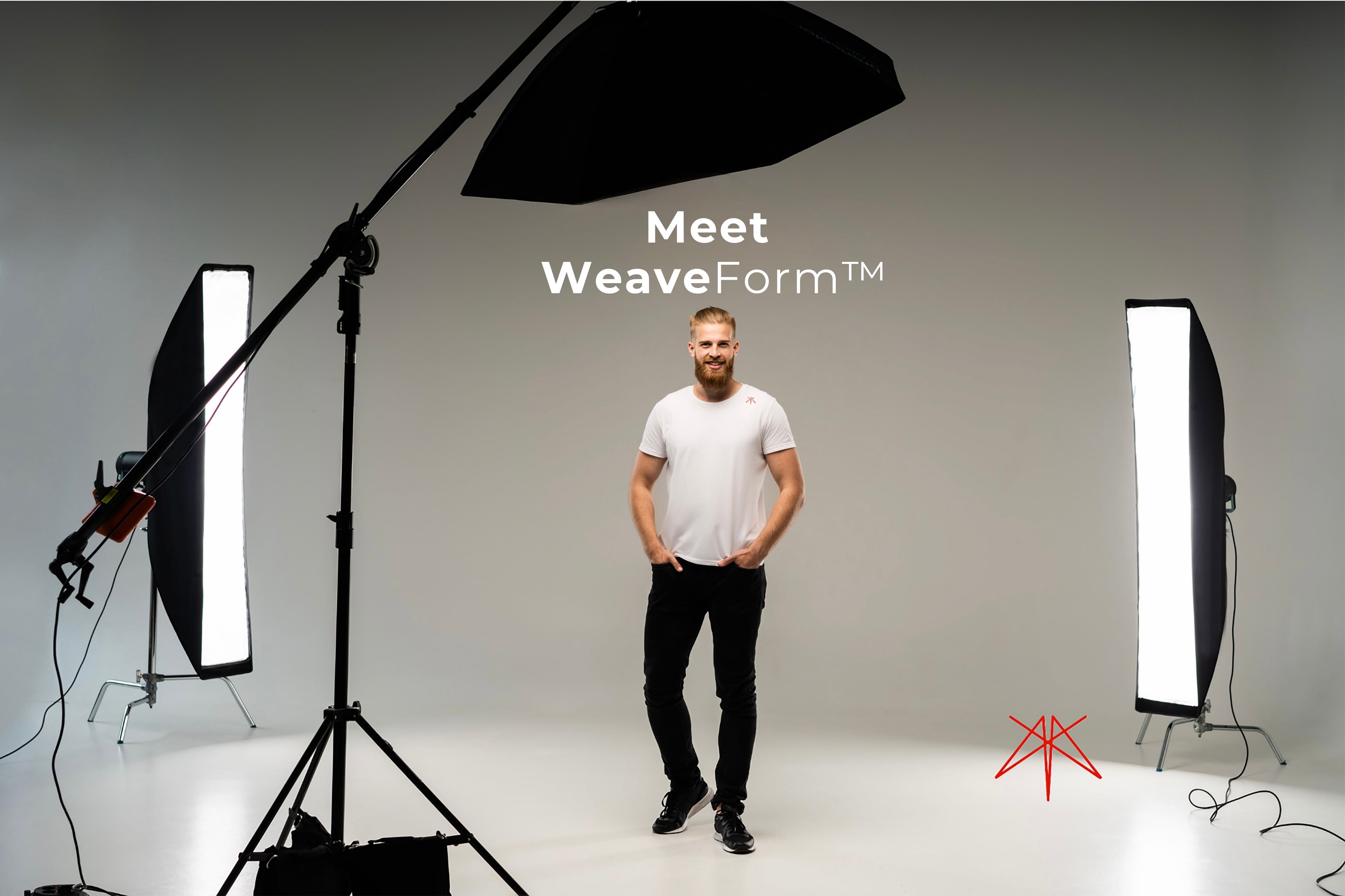 Model wearing Clay & Ash T-shirt made from WeaveForm™ fabric, standing in a studio with professional lighting.